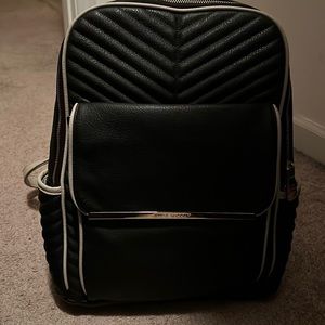 Black Steve Madden back pack 2 side pockets with zip opening